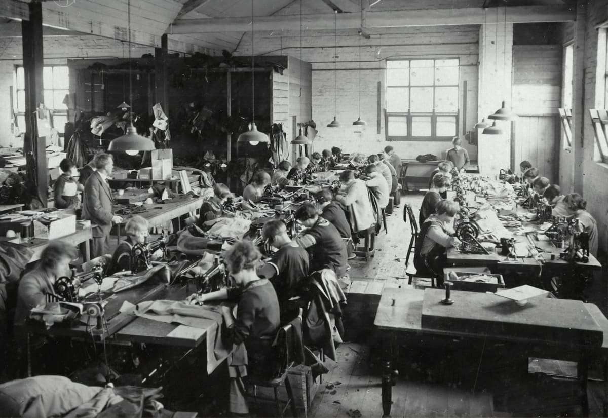 A group of workers on a manufacturing floor